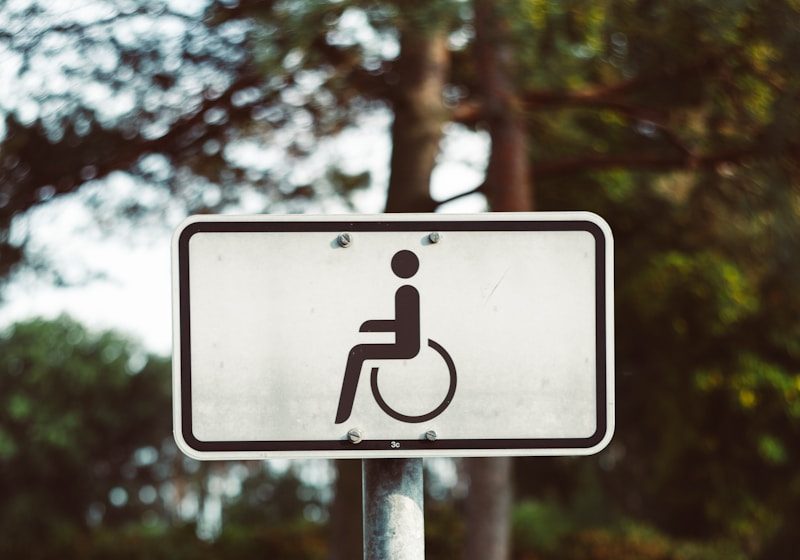 a handicapped sign in the middle of a field
